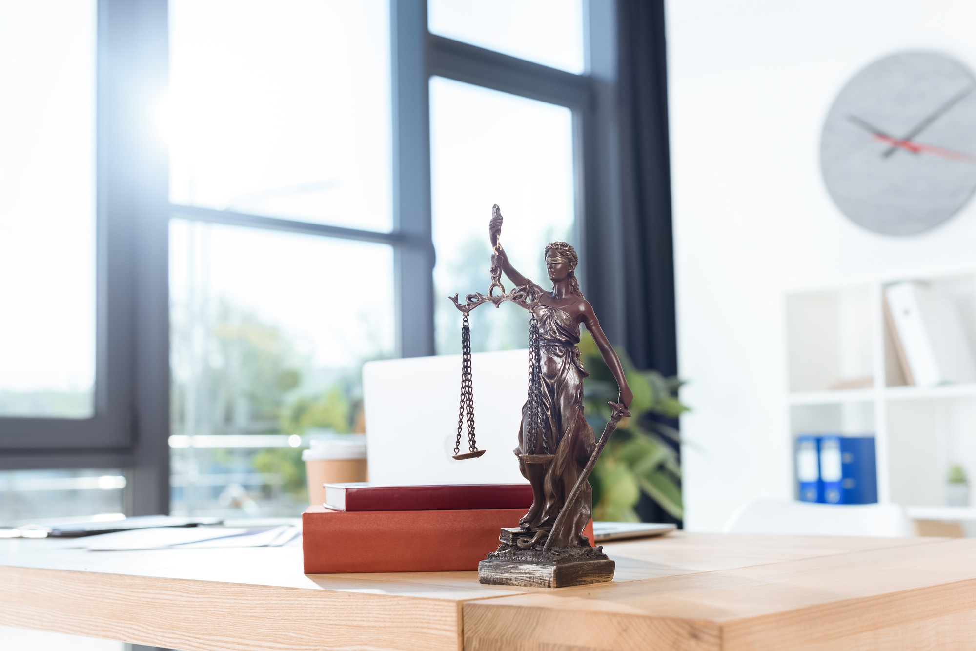 lawyer workplace with themis sculpture in modern office